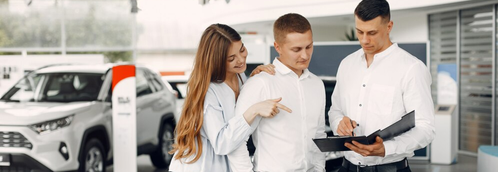 Customers meeting with an auto dealership representative